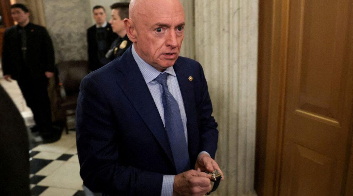U.S. Senator Mark Kelly (D-AZ) winds his watch as he departs the Senate floor after an evening vote at the U.S. Capitol in Washington, D.C., U.S., January 12, 2026. (Reuters/Jonathan Ernst/File Photo)