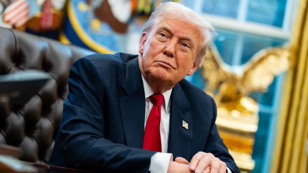 Image of President Donald Trump sitting at the Resolute Desk