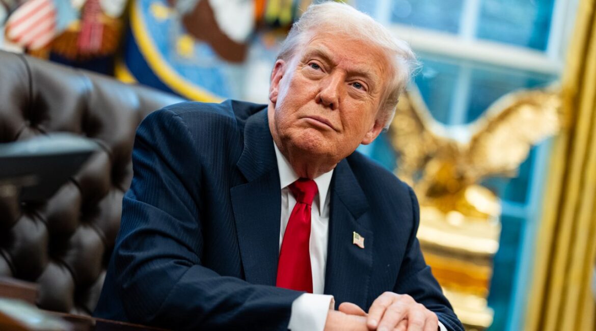 Image of President Donald Trump sitting at the Resolute Desk