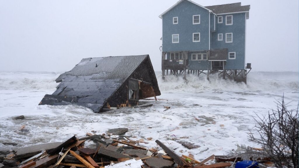 Waves pummeled homes on the coast of Buxton, N.C., destroying a structure, Feb. 1, 2026. Blanketed beaches. Frozen suburbs. Football fields buried in snow. Everywhere in the region, people felt the storm, which caused two deaths. (Daniel Pullen/The New York Times)