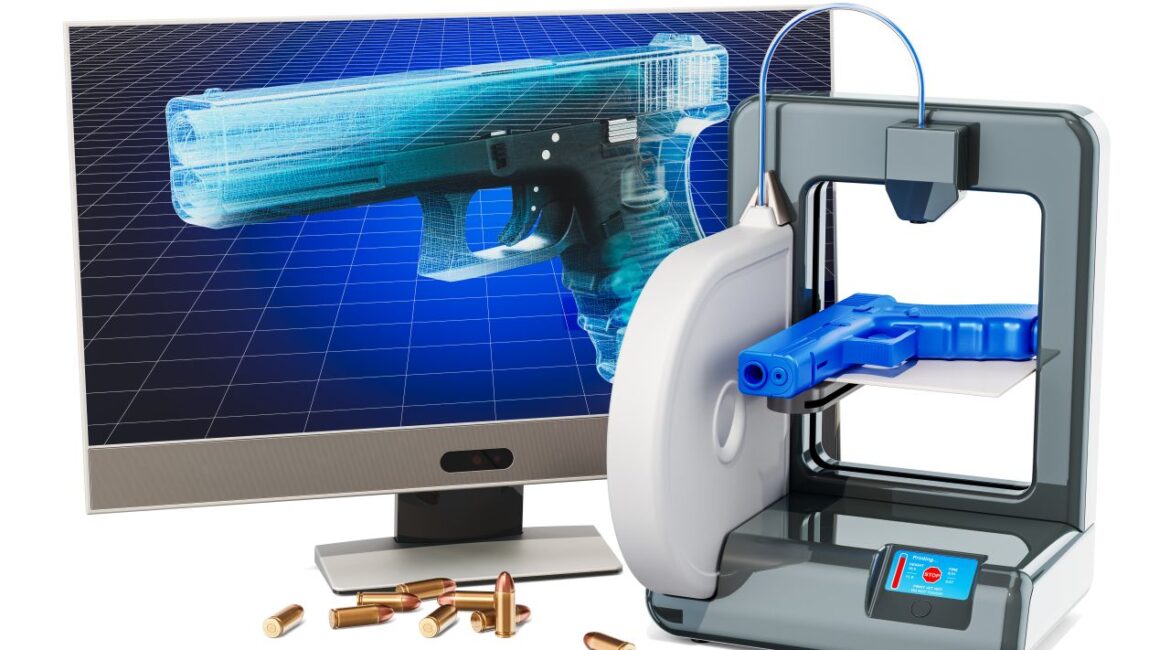 Image of a ghost gun firearm on a computer screen next to a 3-D printer