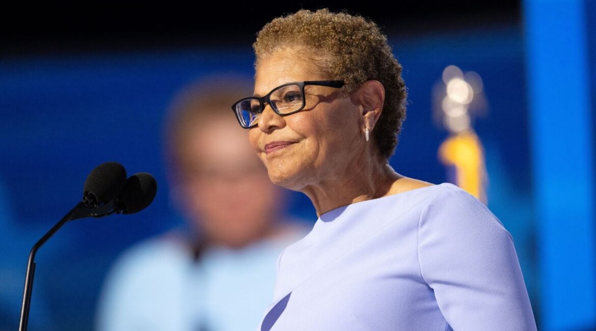 Image of Los Angeles Mayor Karen Bass speaking from a podium. She is wearing a lavender dress.