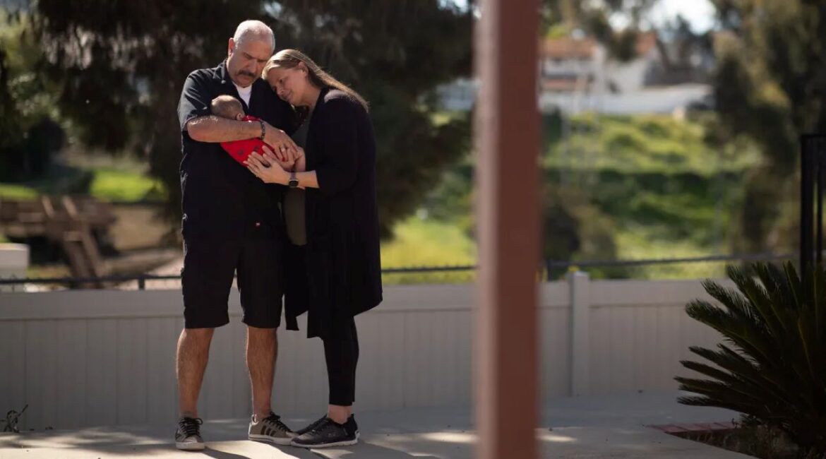 Image of foster care parents holding a 3-month-old baby