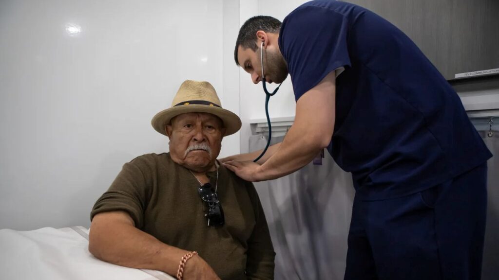 Image of an elderly man getting a checkup at a mobile health clinic