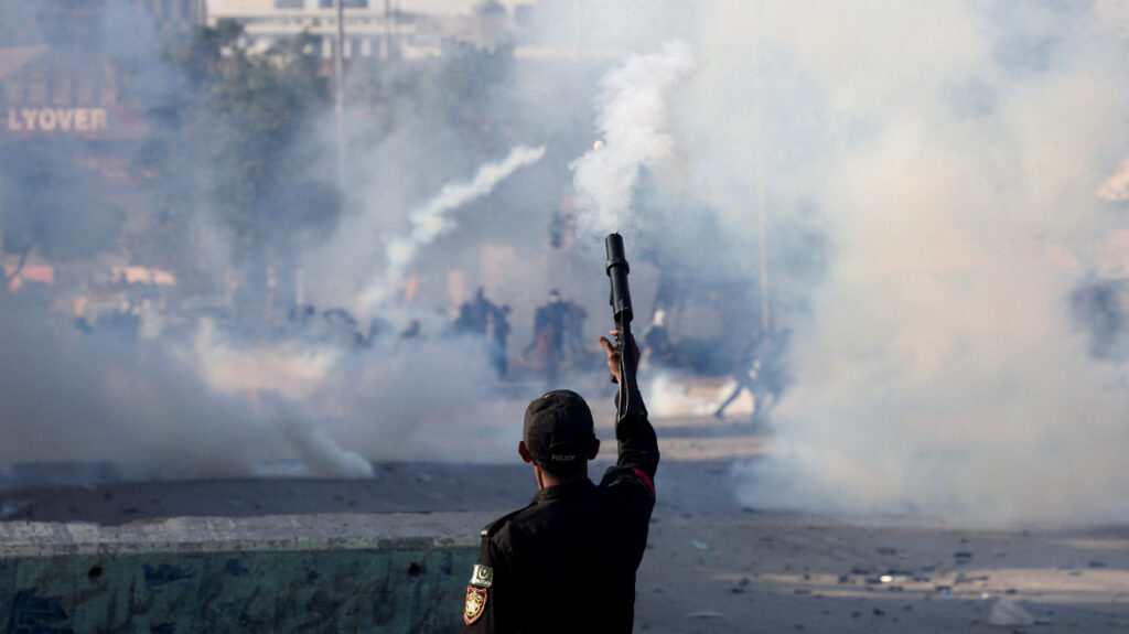 A police officer fires a teargas shell to disperse a protest outside the U.S. and Israeli strikes on Iran that killed Iran's Supreme Leader Ayatollah Ali Khamenei, in Karachi, Pakistan, March 1, 2026. (REUTERS/Akhtar Soomro)