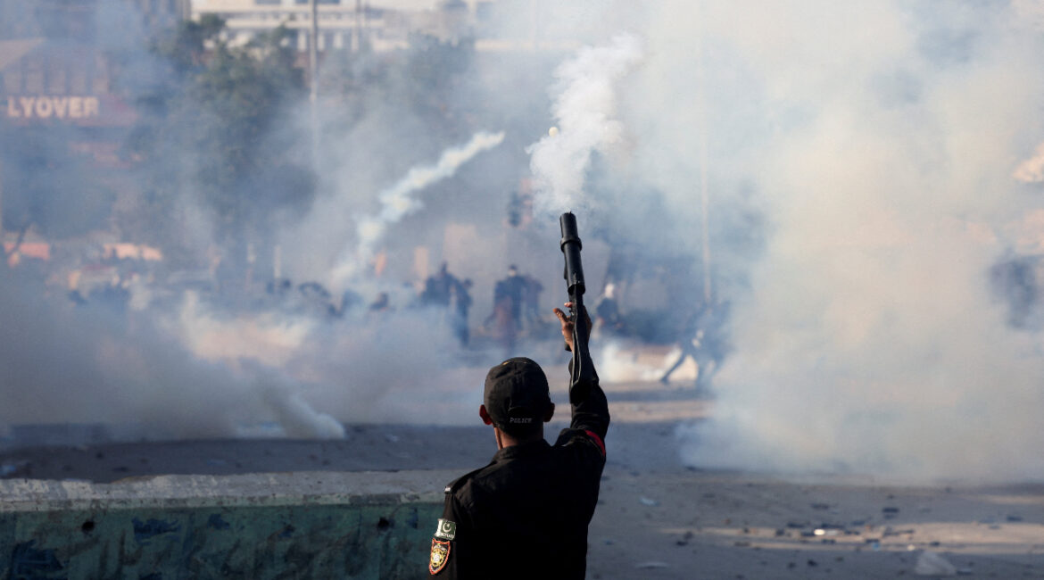 A police officer fires a teargas shell to disperse a protest outside the U.S. and Israeli strikes on Iran that killed Iran's Supreme Leader Ayatollah Ali Khamenei, in Karachi, Pakistan, March 1, 2026. (REUTERS/Akhtar Soomro)