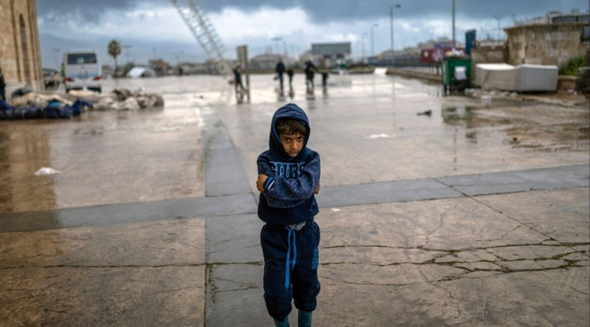 A boy stands outside the stadium in Beirut, Lebanon, that is housing families displaced by the fighting on Friday, March 20, 2026. The number of Lebanese killed rose to more than 1,000, Lebanon’s health ministry said on Thursday. (Diego Ibarra Sánchez/The New York Times)