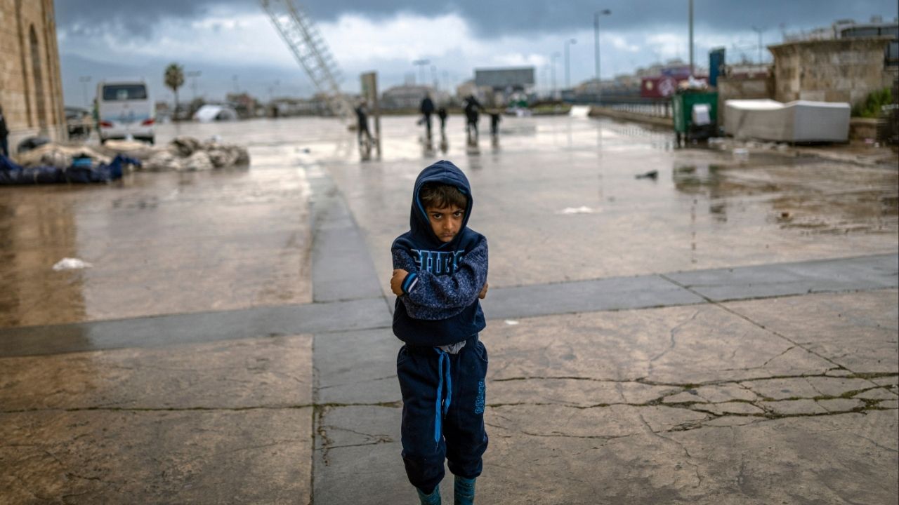 A boy stands outside the stadium in Beirut, Lebanon, that is housing families displaced by the fighting on Friday, March 20, 2026. The number of Lebanese killed rose to more than 1,000, Lebanon’s health ministry said on Thursday. (Diego Ibarra Sánchez/The New York Times)