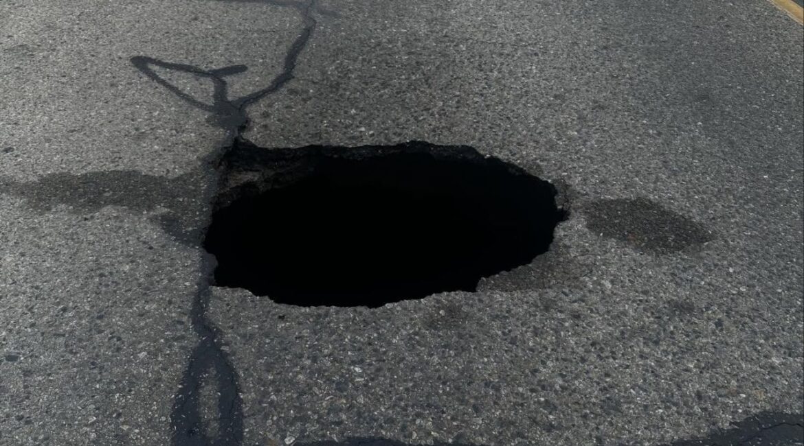 A large sinkhole forced the complete closure of Conyer Street in Visalia on Wednesday, March 4, 2026, with crews working to repair the damage as police warned motorists to avoid the area and expect delays during school traffic hours. (Visalia PD)