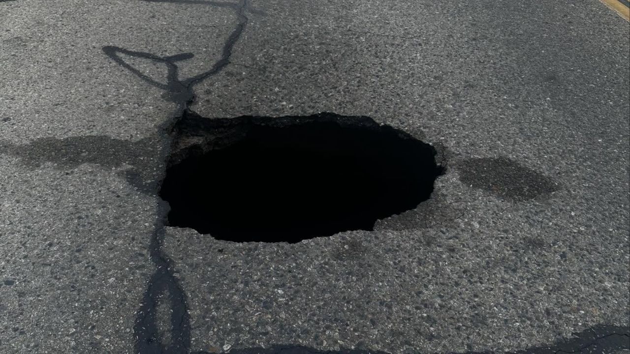 A large sinkhole forced the complete closure of Conyer Street in Visalia on Wednesday, March 4, 2026, with crews working to repair the damage as police warned motorists to avoid the area and expect delays during school traffic hours. (Visalia PD)