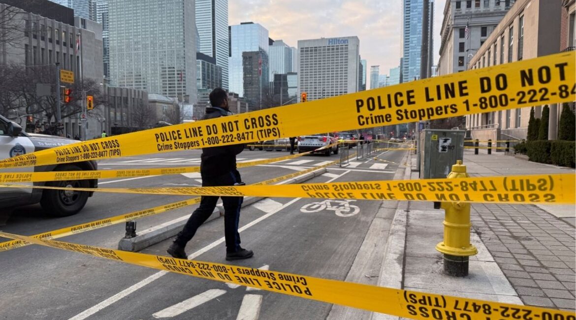 A member of law enforcement personnel works at the scene outside the U.S. Consulate after shots were fired, in Toronto, Ontario, Canada, March 10, 2026. Picture taken with a mobile phone. (Reuters/Kyaw Soe Oo)