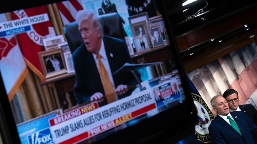 A monitor displays television news coverage of President Donald Trump’s remarks on NATO and the war with Iran as House Majority Leader Steve Scalise (R-La.) speaks to reporters on Capitol Hill on Tuesday, March 17, 2026. Looking on at right is House Speaker Mike Johnson (R-La.). Trump told reporters at the White House on Tuesday that he is not afraid to put U.S. troops on the ground in Iran, and that the United States does not “need or desire” any help from U.S. allies to open the Strait of Hormuz. (Nathan Howard/The New York Times)