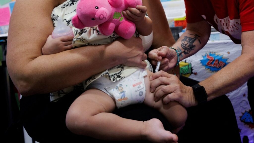 A one-year-old receives a dose of Moderna Spikevax (COVID-19 Vaccine, mRNA) at Skippack Pharmacy in Schwenksville, Pennsylvania, U.S. October 2, 2025. (Reuters/Hannah Beier)