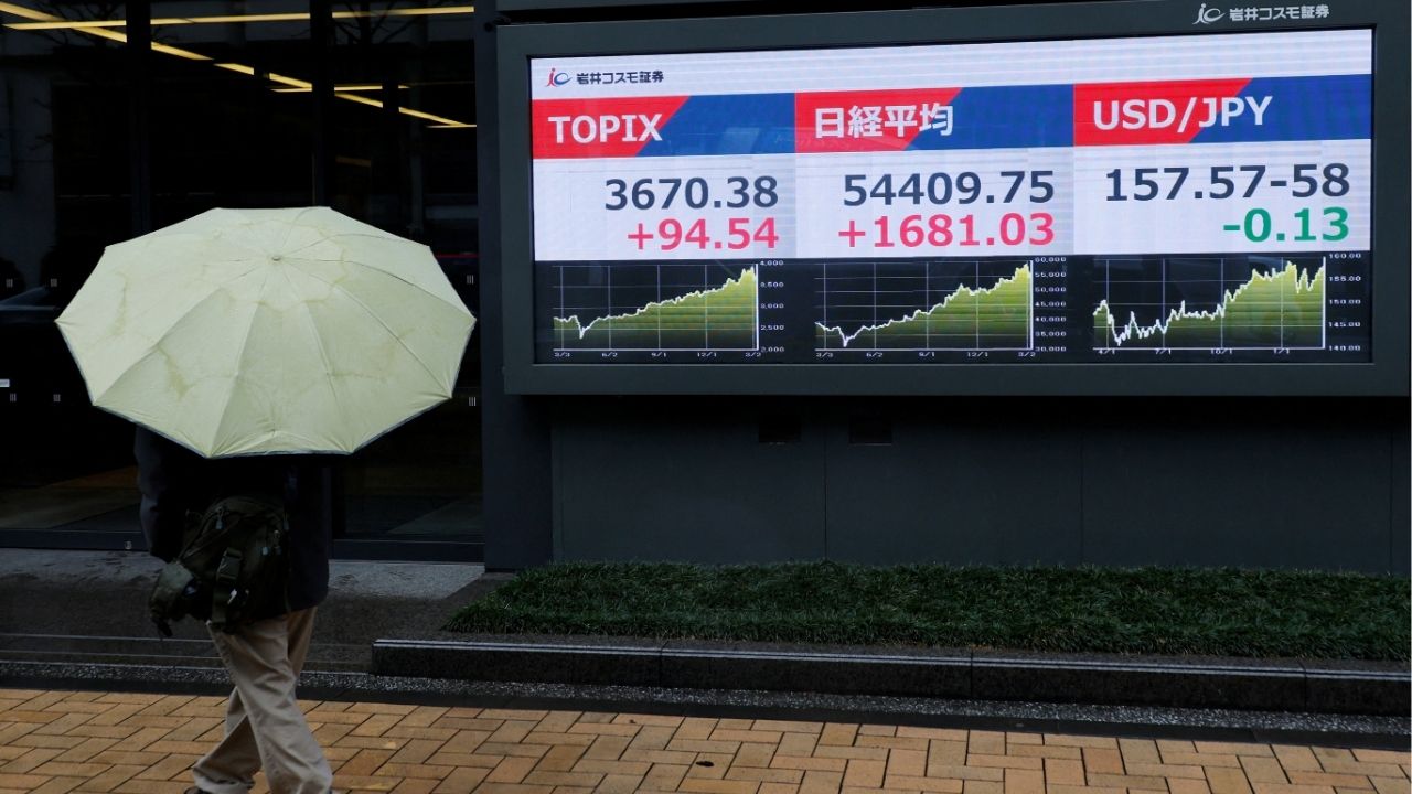 A pedestrian looks at a stock quotation board showing the Topix average, the Nikkei share average and the exchange rate between Japanese yen and U.S. dollar outside a brokerage in Tokyo, Japan, March 10, 2026. (Reuters/Kim Kyung-Hoon)