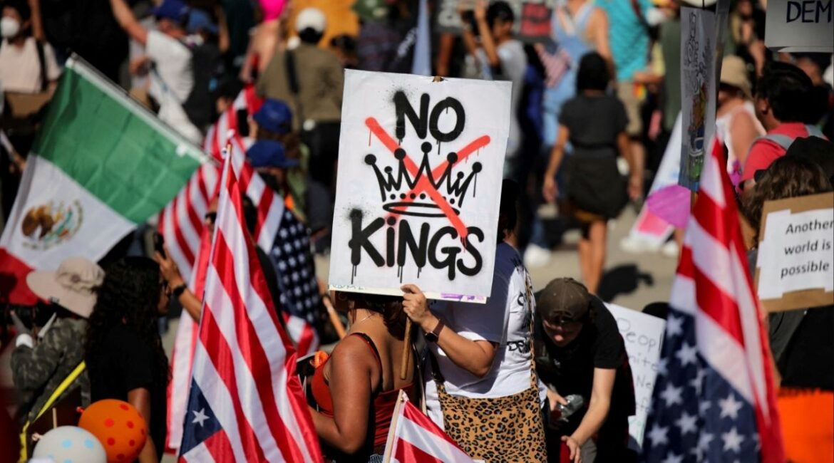 A protester holds a sign reading "NO KINGS" with a crown illustration crossed out during a "No Kings" protest against U.S. President Donald Trump's policies, outside City Hall in Los Angeles, California, U.S., October 18, 2025. (Reuters File)