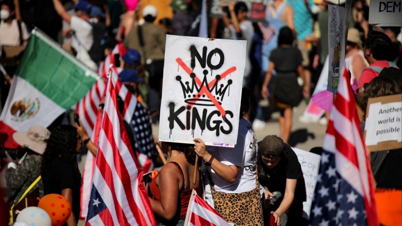 A protester holds a sign reading "NO KINGS" with a crown illustration crossed out during a "No Kings" protest against U.S. President Donald Trump's policies, outside City Hall in Los Angeles, California, U.S., October 18, 2025. (Reuters File)