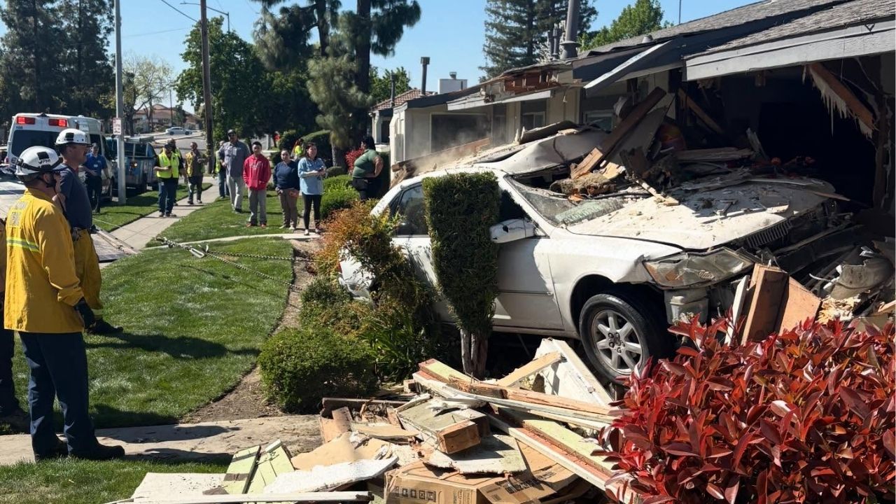 A vehicle veered off the road and crashed into a Fresno apartment building, causing minor injuries to the car's two occupants and displacing a family of three due to severe structural and gas line damage on Monday, March 9, 2026. (Fresno FD)