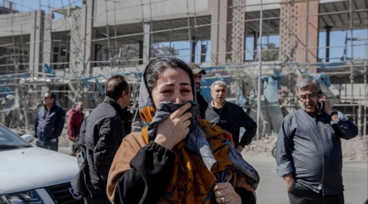 A woman cries near a Diplomatic Police station destroyed by airstrikes in Tehran, on Tuesday, March 3, 2026. Global market volatility continued for a third day on Wednesday, as investors assessed the effects of rising energy costs stemming from the war in Iran. (Arash Khamooshi/The New York Times)
