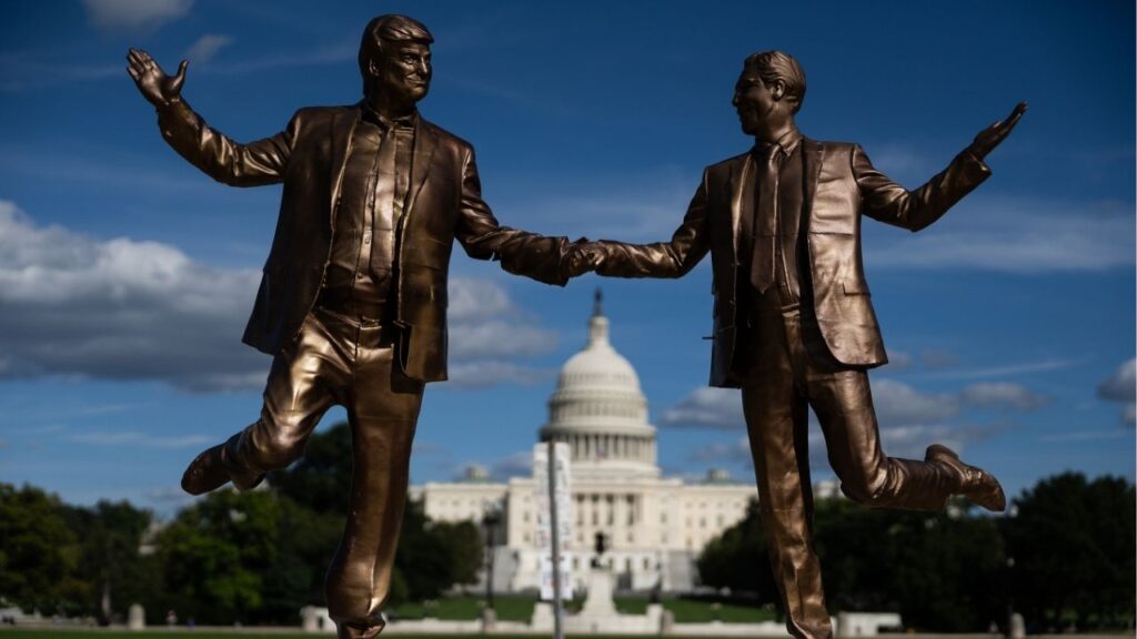 A work of protest art titled “Best Friends Forever,” depicting President Donald Trump, left, and Jeffrey Epstein, the deceased sex offender, on the National Mall near the U.S. Capitol in Washington, Oct. 2, 2025. A new statue on the National Mall titled “The King of the World,” depicting the president and Epstein enacting a pose from the movie “Titanic,” is the latest in a series of satirical installations created by an anonymous group of artists called the Secret Handshake. (Tierney L. Cross/The New York Times)