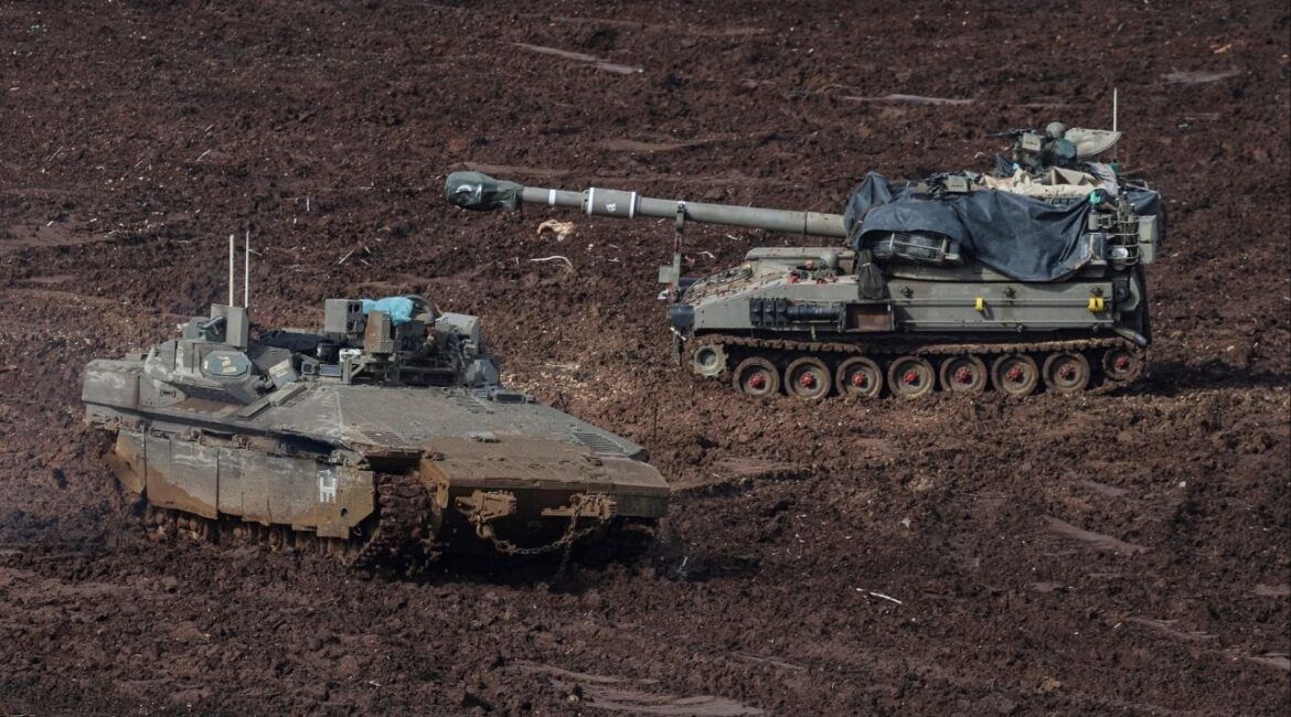 An armoured personnel carrier (APC) and a self-propelled artillery unit at the Israeli side of the border with Lebanon, amid escalation between Iran-backed Hezbollah and Israel, and amid the U.S.-Israeli conflict with Iran, in northern Israel, March 20, 2026. REUTERS/Tyrone Siu