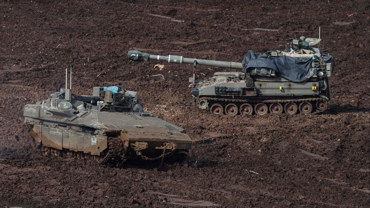 An armoured personnel carrier (APC) and a self-propelled artillery unit at the Israeli side of the border with Lebanon, amid escalation between Iran-backed Hezbollah and Israel, and amid the U.S.-Israeli conflict with Iran, in northern Israel, March 20, 2026. REUTERS/Tyrone Siu