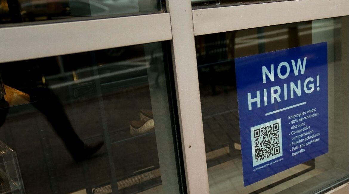 An employee hiring sign with a QR code is seen in a window of a business in Arlington, Virginia, U.S., April 7, 2023. (Reuters/Elizabeth Frantz)