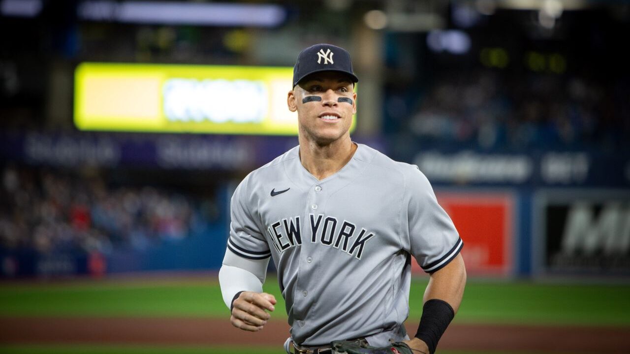 Image of New York Yankees star Aaron Judge running off the field in a night game