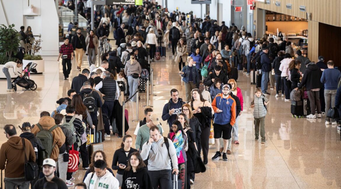 Image of long lines of people waiting to pass through screening at LaGuardia Airport in New York