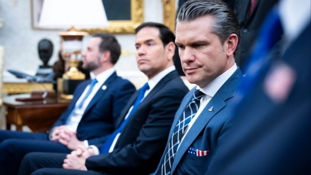 Defense Secretary Pete Hegseth, second looks on as President Donald Trump meets with Prime Minister of Japan Sanae Takaichi of Japan in the Oval Office on Thursday, March 19, 2026. Hegseth has framed U.S. military actions as bigger than politics or U.S. foreign policy. (Doug Mills/The New York Times)