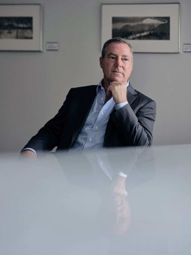 Image of Brad Karp sitting with his hand on his chin