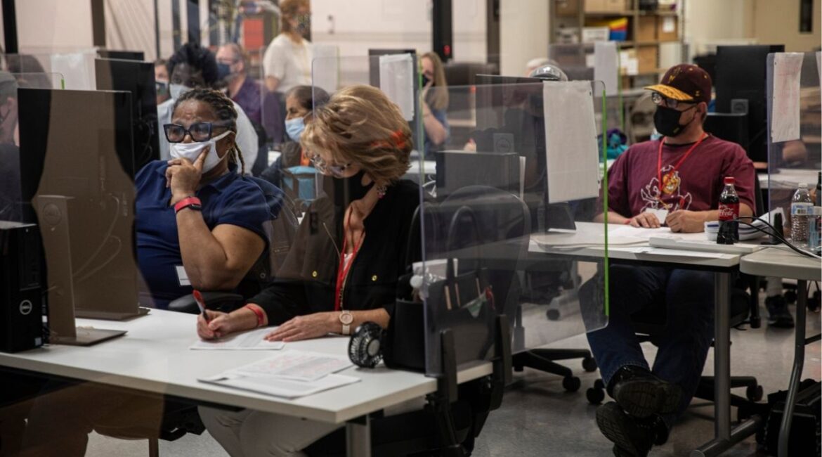Election workers tabulate ballots at the Maricopa County Recorder’s office in Phoenix, Nov. 5, 2020. The FBI has expanded its criminal investigation into purported irregularities in the 2020 presidential election, issuing a grand jury subpoena for reams of information about voting results in Maricopa County, Ariz., a Democratic stronghold in the swing state, according to three people familiar with the matter. (Adriana Zehbrauskas/The New York Times)