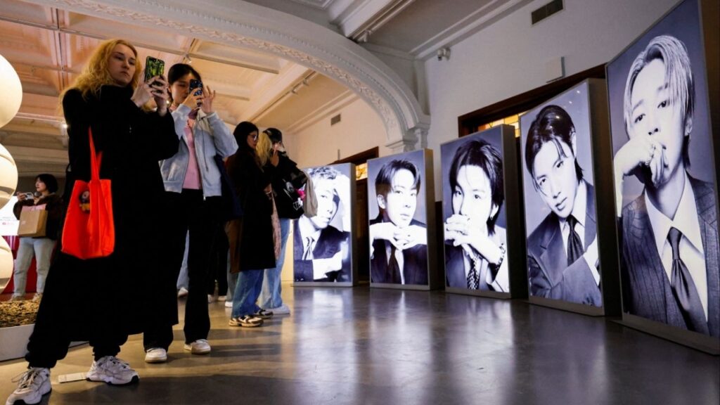 Fans of Kpop boy band BTS, known as ARMY, photograph portraits of the members at a pop-up exhibition ahead of the group's upcoming free comeback concert, "BTS The Comeback Live Arirang," their first performance in more than three years following the completion of mandatory military service, in Seoul, South Korea, March 20, 2026. (Reuters/Kim Soo-hyeon)