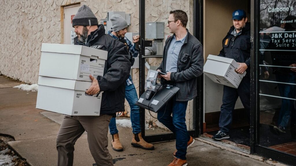 Federal agents execute a search warrant at a home health care service in Bloomington, Minn., Dec. 18, 2025. Minnesota officials sued the Trump administration on Monday over a decision to withhold more than $200 million in Medicaid funds from the state, which has seen widespread fraud in social service programs. (Jamie Kelter Davis/The New York Times)