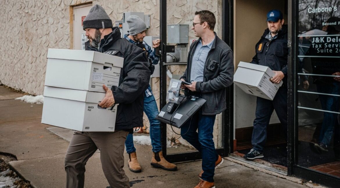 Federal agents execute a search warrant at a home health care service in Bloomington, Minn., Dec. 18, 2025. Minnesota officials sued the Trump administration on Monday over a decision to withhold more than $200 million in Medicaid funds from the state, which has seen widespread fraud in social service programs. (Jamie Kelter Davis/The New York Times)