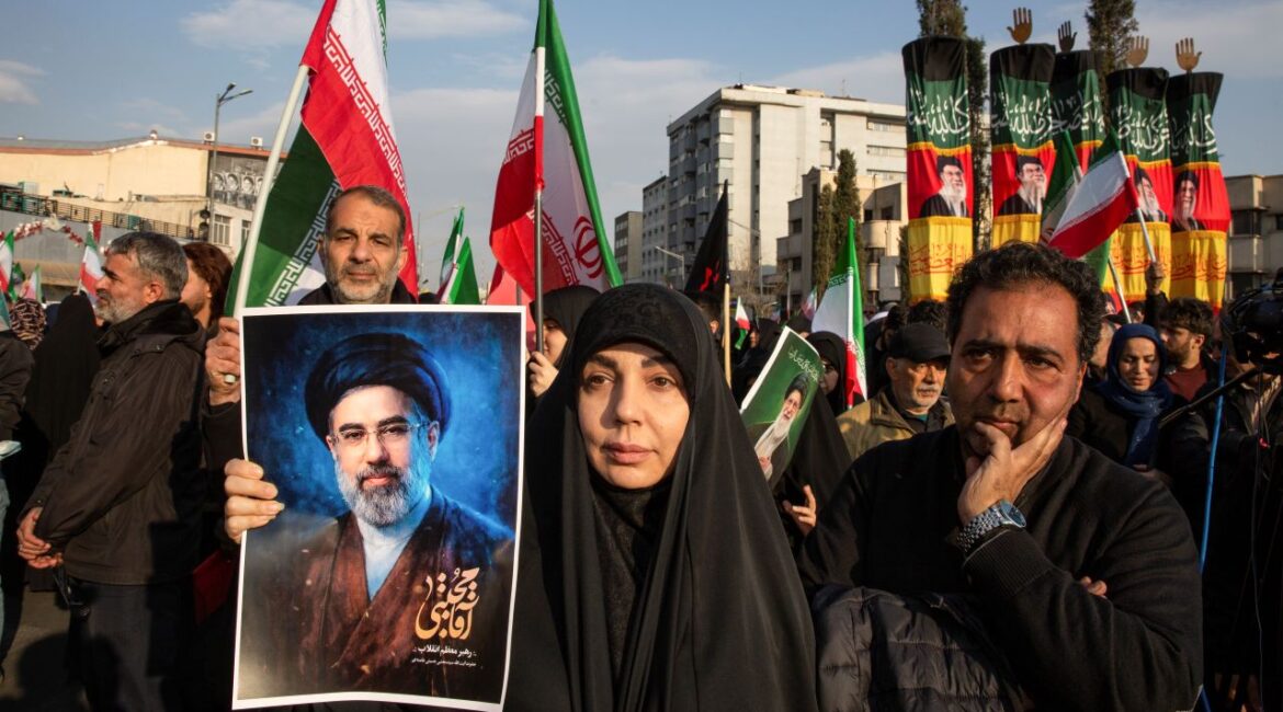 Image of Iranians holding up a portrait of Mojtaba Khamenei