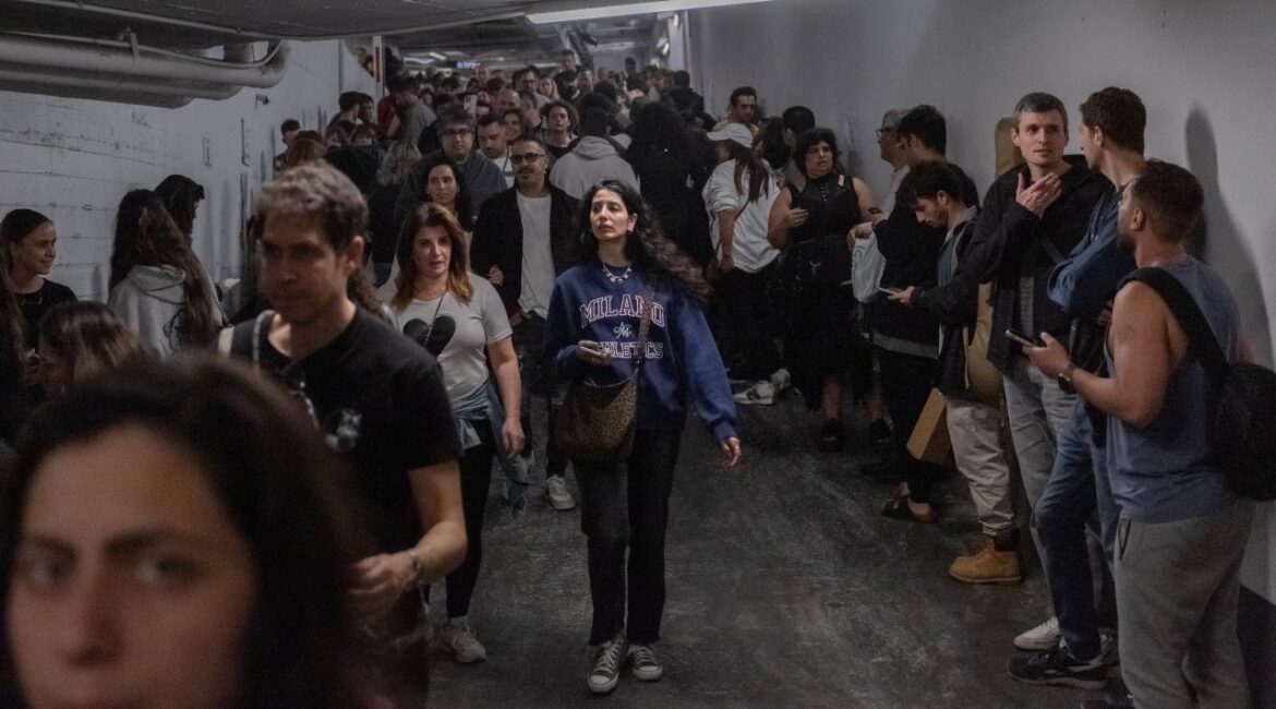 Image of Israelis seeking shelter from an Iranian missile attack in an underground parking garage