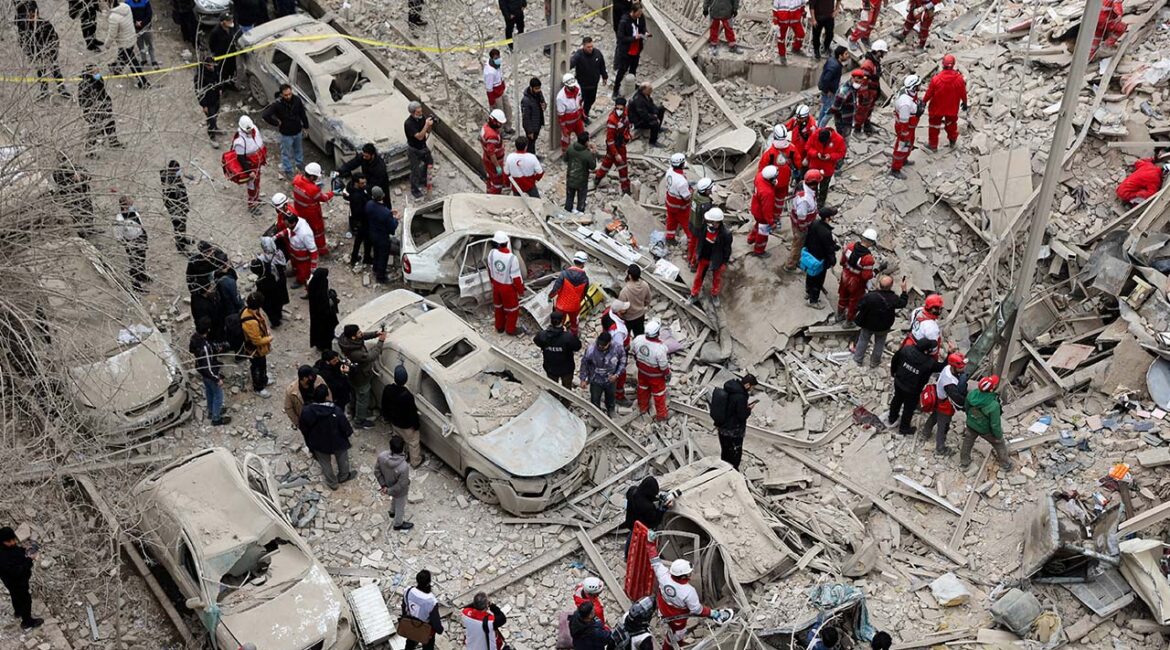 Emergency personnel work at the site of a strike on a residential building, amid the U.S.-Israeli conflict with Iran, in Tehran, Iran, March 16, 2026. (Majid Asgaripour/WANA (West Asia News Agency) via Reuters)