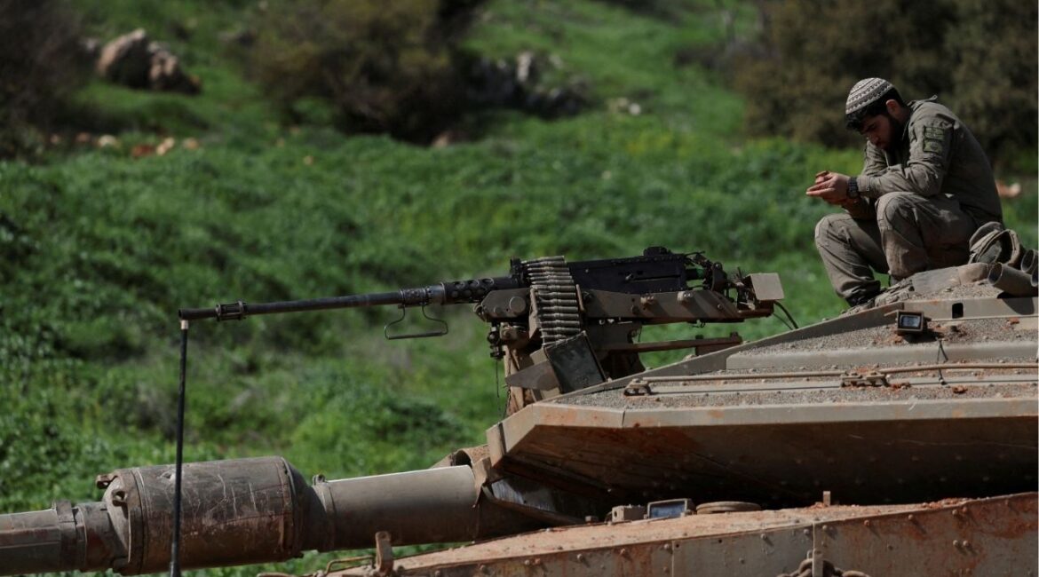 Israeli soldiers sit on a tank on the Israeli side of the border with Lebanon, amid escalation between Hezbollah and Israel, amid the U.S.-Israeli conflict with Iran, in northern Israel, March 6, 2026. (Reuters/Ammar Awad)