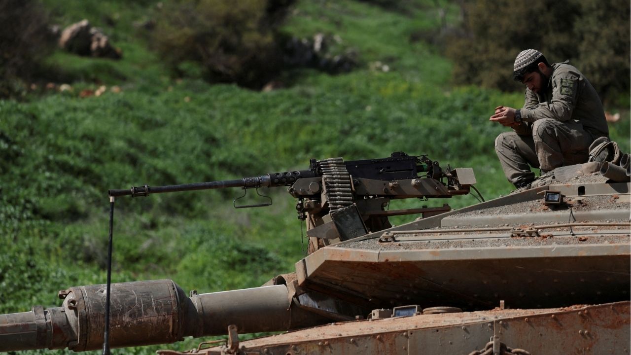 Israeli soldiers sit on a tank on the Israeli side of the border with Lebanon, amid escalation between Hezbollah and Israel, amid the U.S.-Israeli conflict with Iran, in northern Israel, March 6, 2026. (Reuters/Ammar Awad)