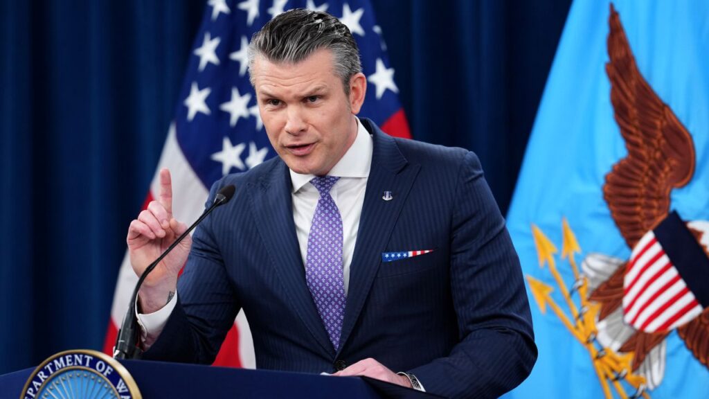 Image of Secretary of Defense Pete Hegseth speaking at a news conference.