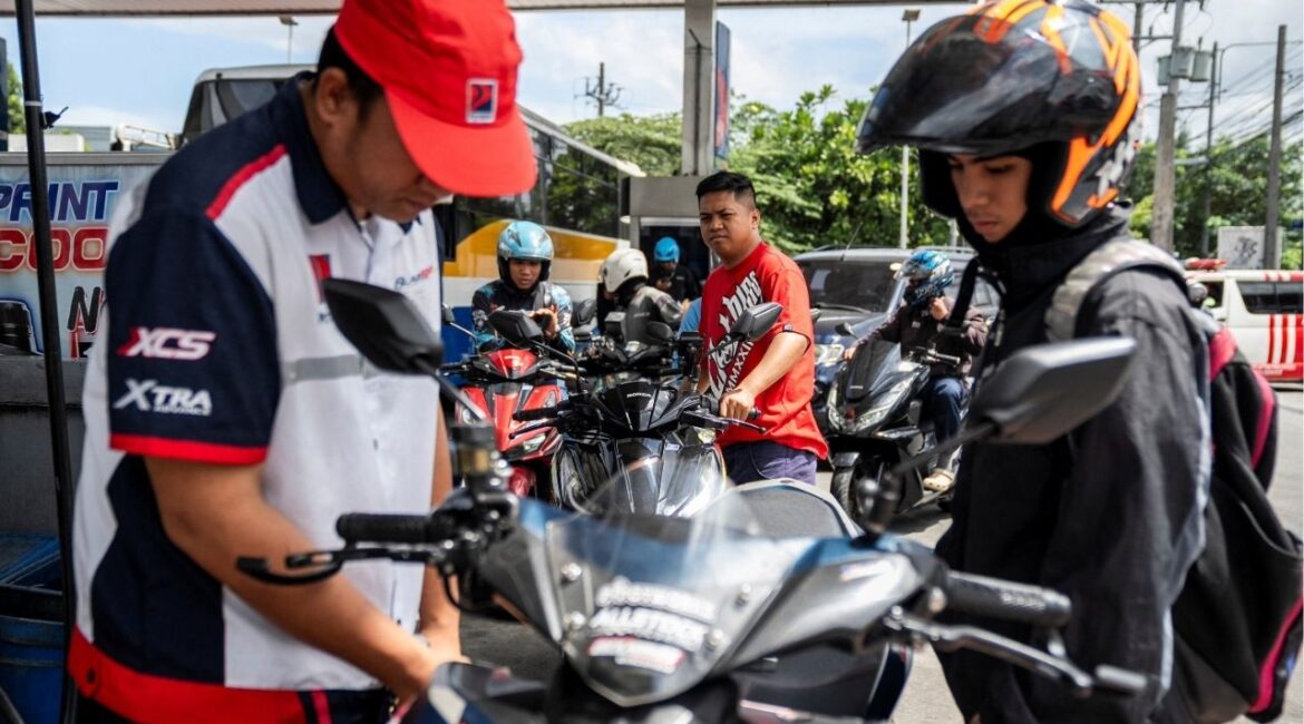 Motorcycle drivers queue while a worker fills up a motorcycle at a gas station as oil prices are expected to increase amid the U.S.-Israel conflict with Iran, in Quezon City, Metro Manila, Philippines, March 9, 2026. (Reuters/Lisa Marie David)