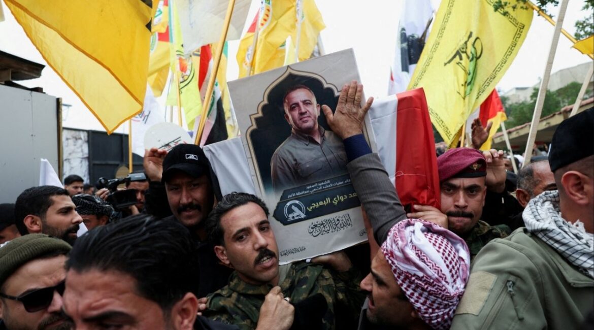 Mourners carry the coffin of Saad al-Baiji, the Popular Mobilization Forces' Anbar operations commander, who was killed in airstrikes that targeted a PMF site in Iraq's western Anbar province, during his funeral, in Baghdad, Iraq, March 24, 2026. (Reuters/Ahmed Saad)
