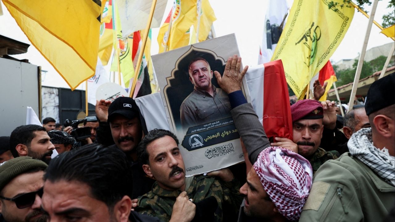 Mourners carry the coffin of Saad al-Baiji, the Popular Mobilization Forces' Anbar operations commander, who was killed in airstrikes that targeted a PMF site in Iraq's western Anbar province, during his funeral, in Baghdad, Iraq, March 24, 2026. (Reuters/Ahmed Saad)