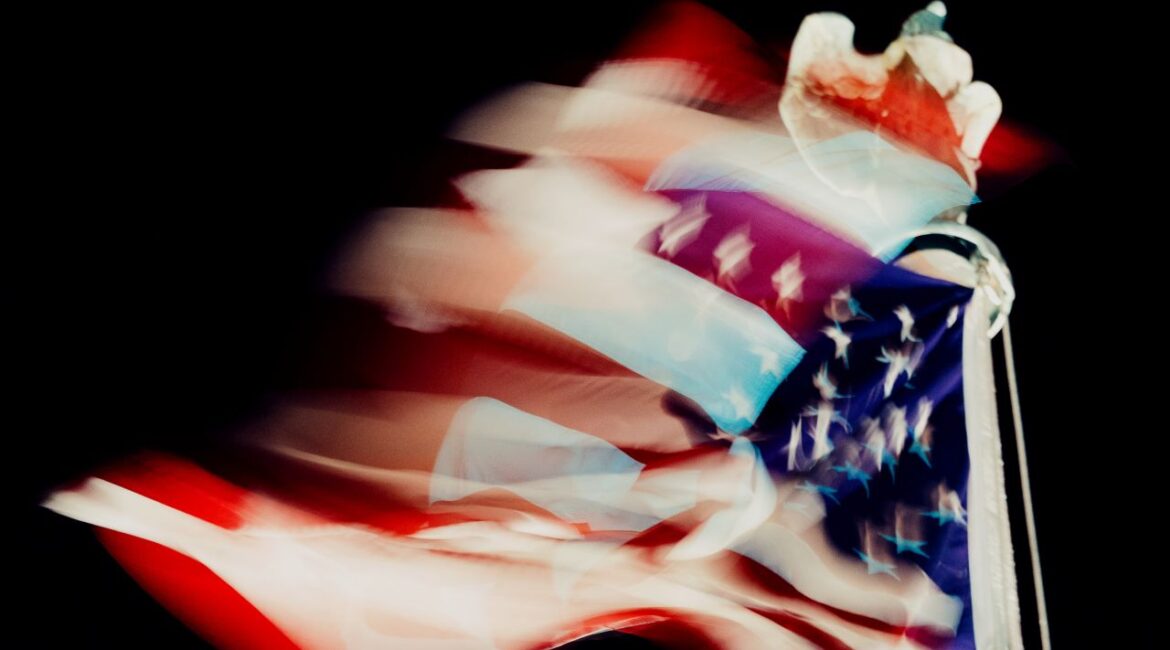 Distorted color image of the US flag blowing in the wind outside the US Supreme Court at night