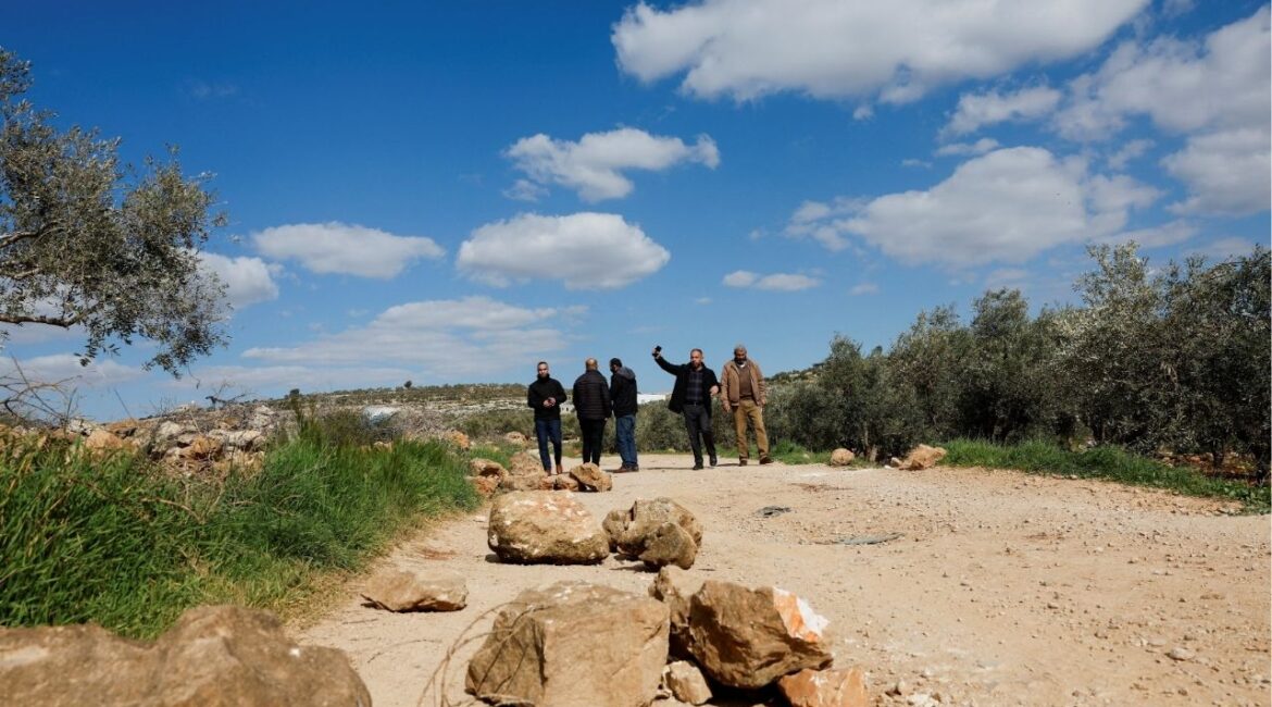 Palestinians stand near bloodstains at the site where Thaer Hamayel was killed during an attack by Israeli settlers on the Palestinians in the village of Abu Falah near Ramallah, in the Israeli-occupied West Bank, March 9, 2026. (Reuters/Ammar Awad)