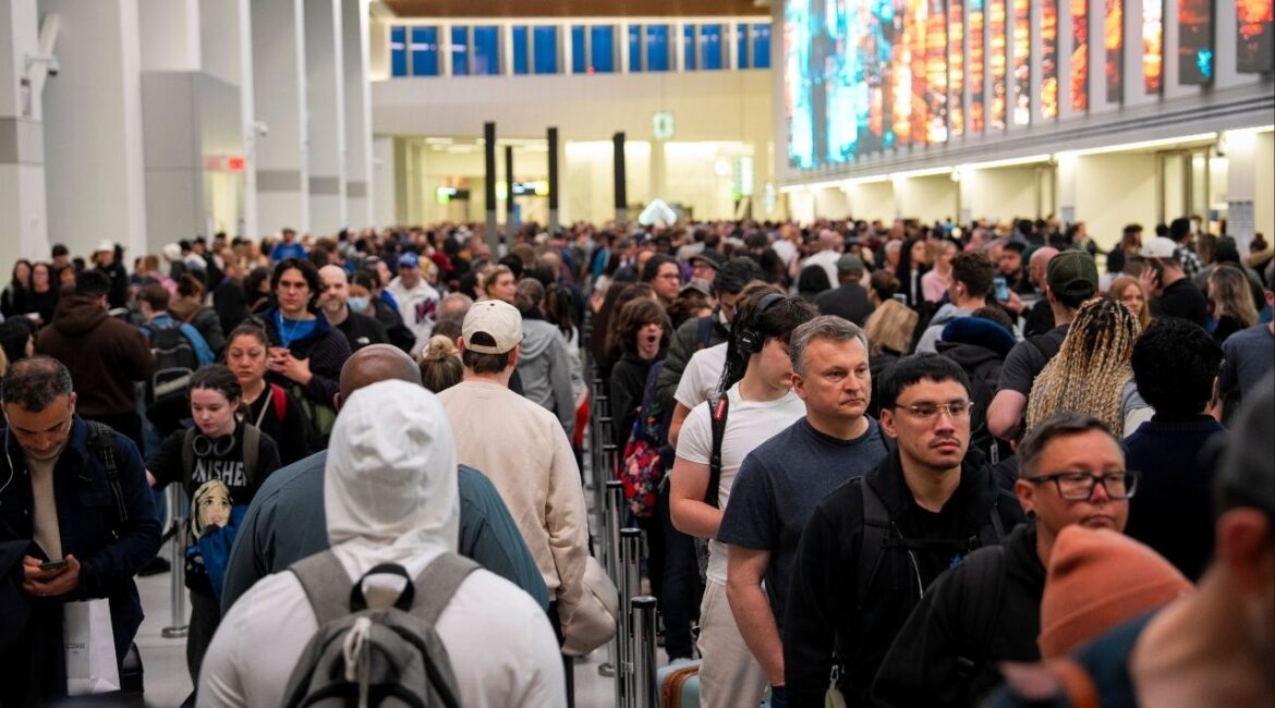 Passengers wait in a long line at a security checkpoint at LaGuardia Airport in New York on Friday morning, March 27, 2026. The Senate voted early Friday to fund the Department of Homeland Security except for its immigration enforcement and deportation operations, raising the prospect of an end to a weekslong partial shutdown that has strained federal workers and caused long waits at airports. (Vincent Alban/The New York Times)