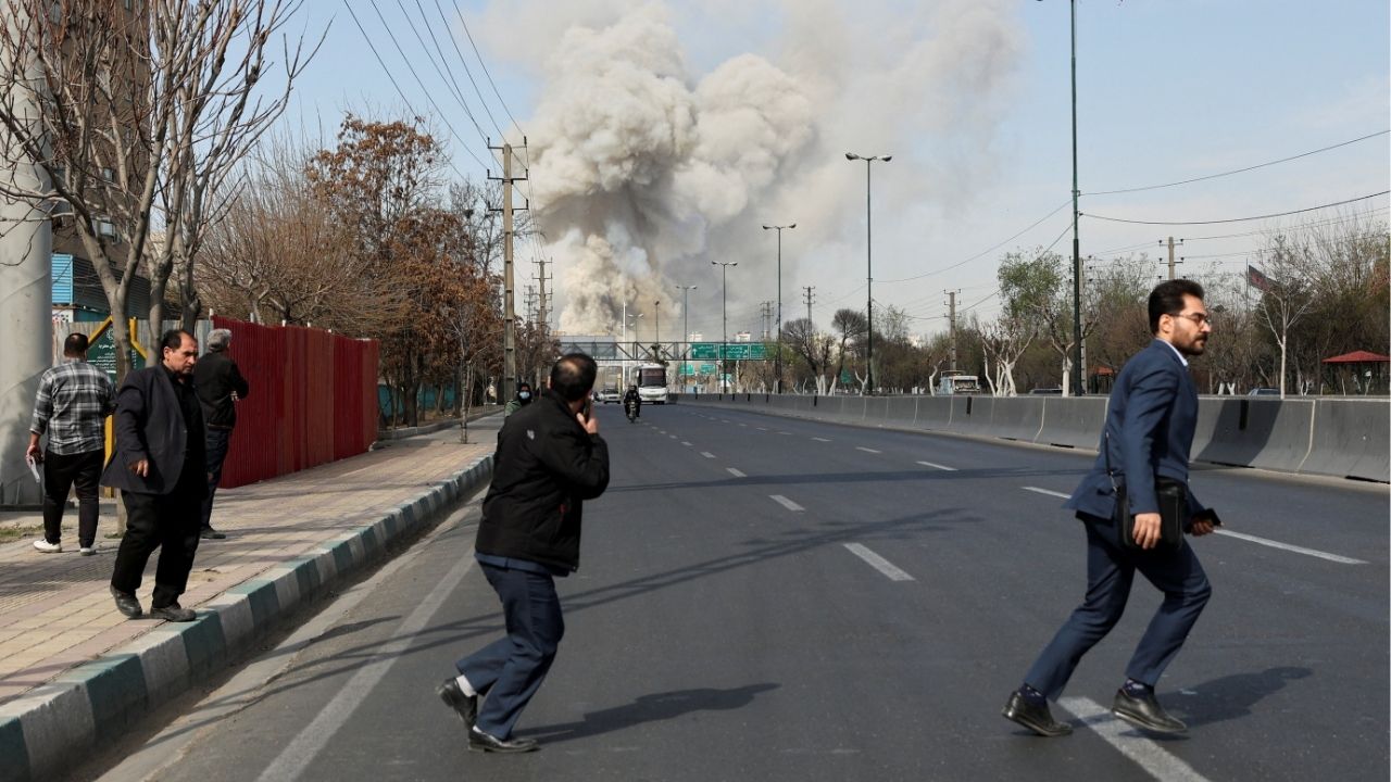People run as smoke rises following an explosion, amid the U.S.-Israeli conflict with Iran, in Tehran, Iran, March 5, 2026. (Majid Asgaripour/WANA (West Asia News Agency) via Reuters)