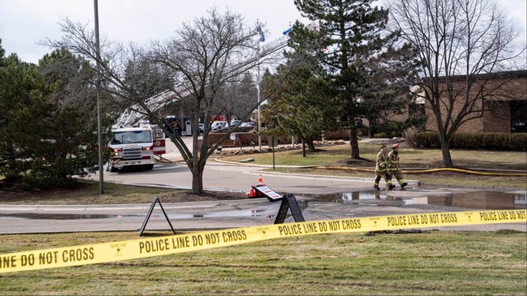 Police officers and firefighters at the scene where a truck was rammed into Temple Israel, a synagogue in West Bloomfield Township, Mich., March 12, 2026. An attacker is dead after plowing a vehicle into a synagogue on Thursday outside Detroit and then exchanging gunfire with security guards in what the authorities described as a “targeted act of violence against the Jewish community.” (Sarah Rice/The New York Times)