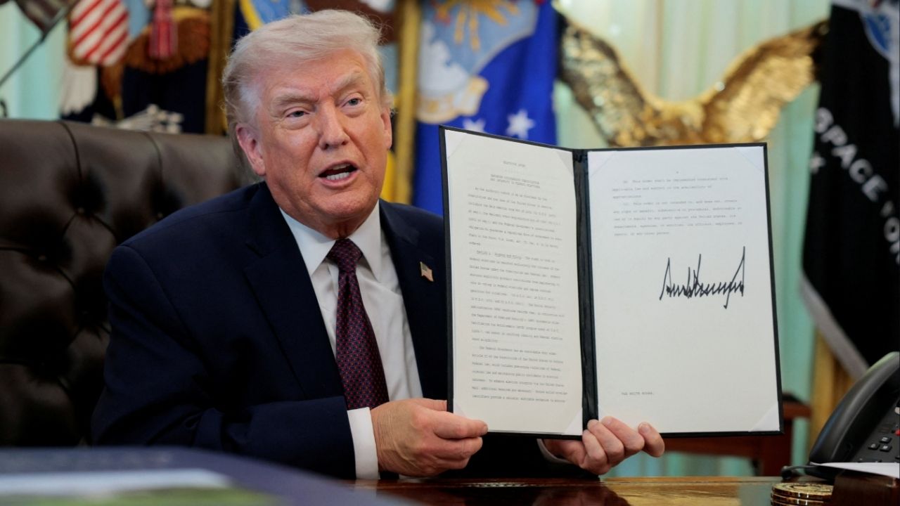 President Donald Trump speaks as he shows a signed executive order on mail ballots, in the Oval Office of the White House in Washington, D.C., March 31, 2026. (Reuters/Evan Vucci)