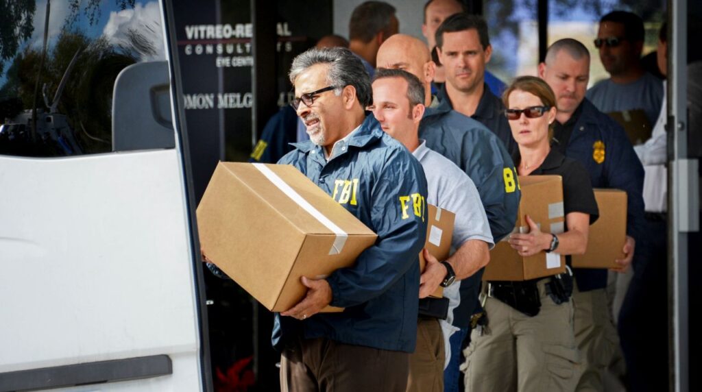 Image of FBI agents removing boxes of records from a Florida doctor's office